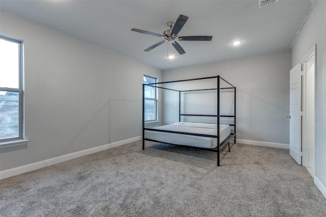 unfurnished bedroom featuring light carpet and ceiling fan