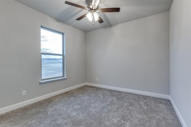 carpeted spare room featuring ceiling fan