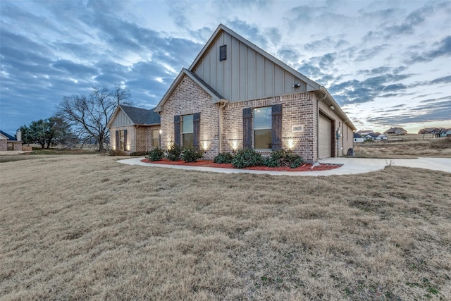 view of front of house with a garage and a yard