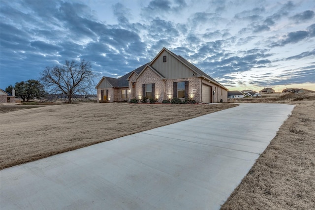 view of front of house with a garage and a lawn