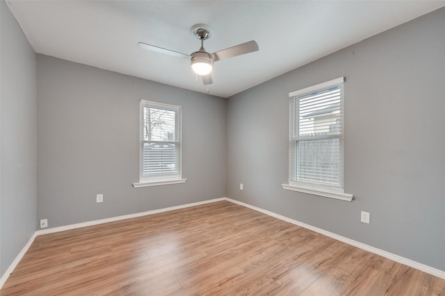 unfurnished room featuring plenty of natural light, ceiling fan, and light wood-type flooring