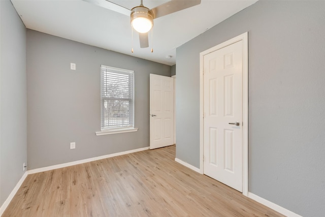 unfurnished bedroom with light hardwood / wood-style floors and ceiling fan