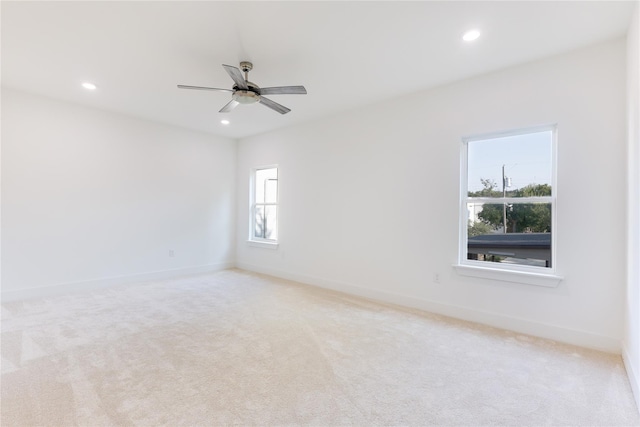 unfurnished room featuring light carpet and ceiling fan