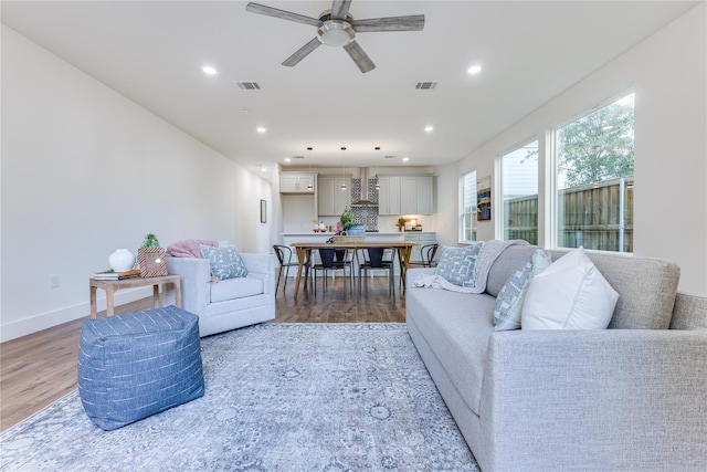 living room with hardwood / wood-style flooring and ceiling fan