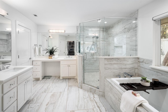 bathroom featuring vanity and separate shower and tub