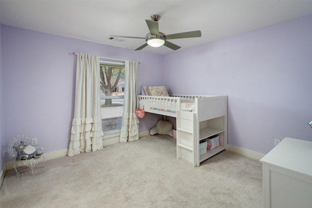 bedroom featuring light carpet and ceiling fan