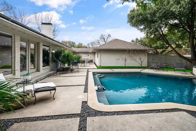 view of swimming pool with a patio