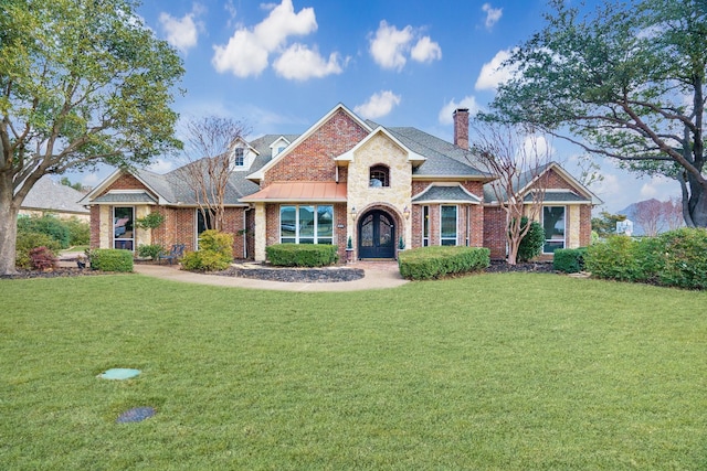 view of front of property with a front yard and french doors