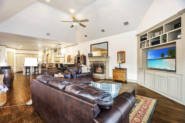 living room with ceiling fan, high vaulted ceiling, dark hardwood / wood-style floors, and a brick fireplace