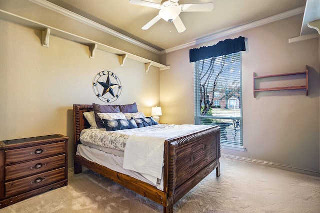 carpeted bedroom with ornamental molding and ceiling fan