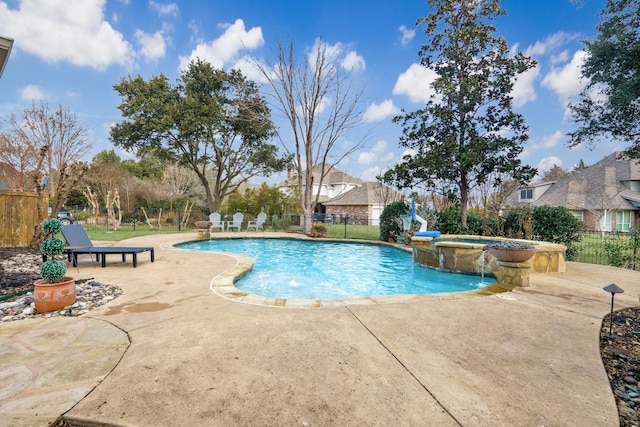 view of pool featuring an in ground hot tub, pool water feature, and a patio area