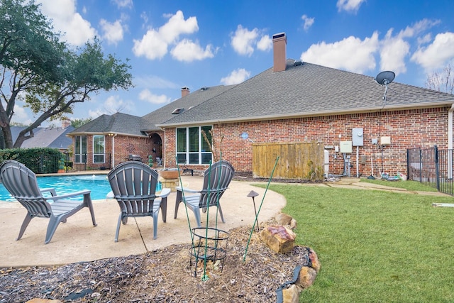 view of pool featuring a yard and a patio