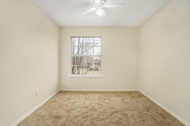 carpeted empty room featuring ceiling fan