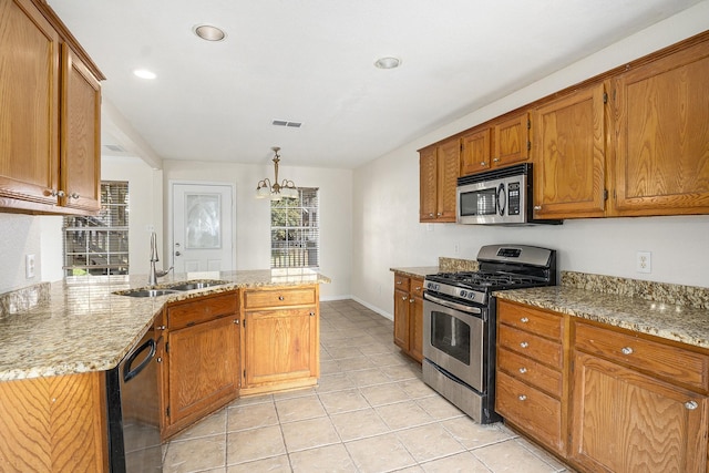 kitchen featuring light tile patterned flooring, sink, pendant lighting, stainless steel appliances, and light stone countertops