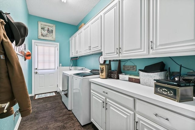 laundry area with dark wood-type flooring, cabinets, washer and clothes dryer, and a textured ceiling