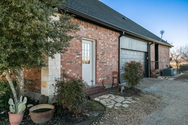 exterior space with cooling unit and a garage