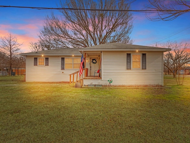 single story home featuring a yard