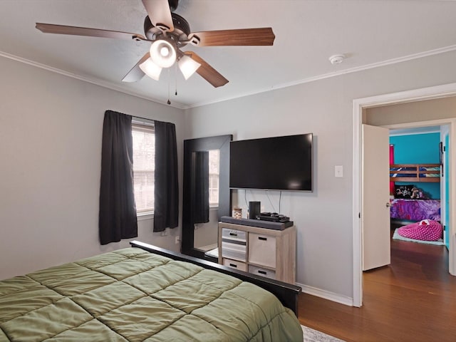 bedroom featuring dark wood-type flooring, ornamental molding, and ceiling fan