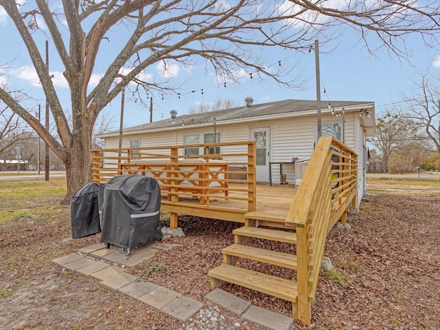 rear view of house with a wooden deck