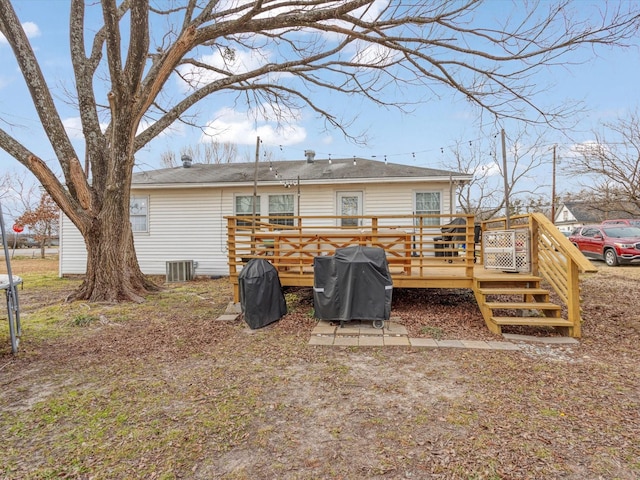 rear view of house with central AC and a deck