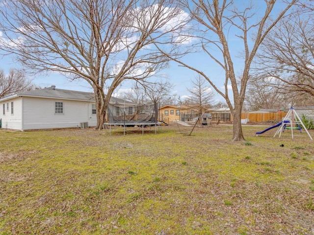 view of yard with a playground and a trampoline