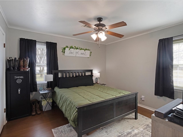 bedroom with wood-type flooring, ceiling fan, and crown molding