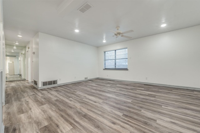 spare room featuring ceiling fan and light hardwood / wood-style flooring