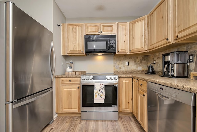 kitchen featuring light brown cabinetry, stainless steel appliances, light stone countertops, light hardwood / wood-style floors, and decorative backsplash