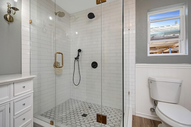 bathroom with an enclosed shower, wood-type flooring, and toilet