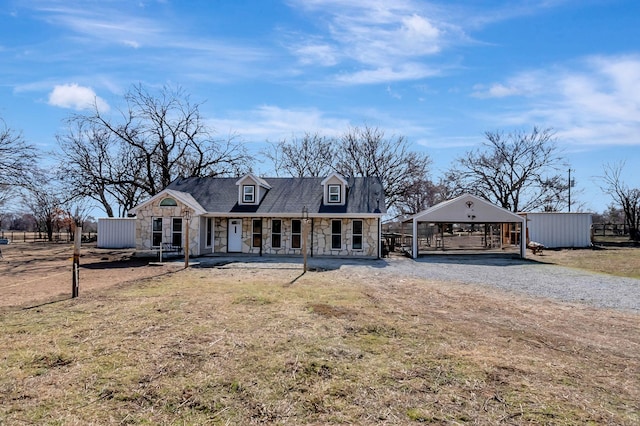 view of front of property with a carport, a porch, and a front lawn