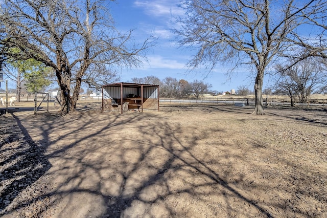 view of yard with an outbuilding and a rural view