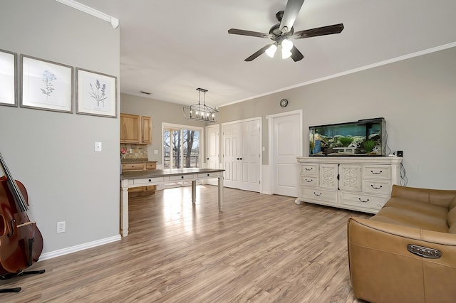 living room featuring crown molding, ceiling fan with notable chandelier, and light hardwood / wood-style floors