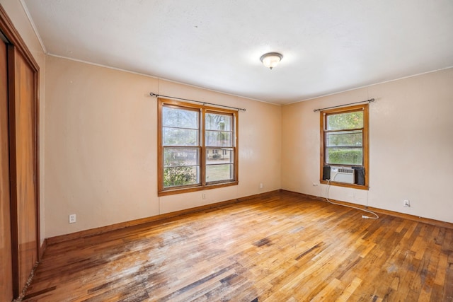 spare room featuring hardwood / wood-style flooring and cooling unit