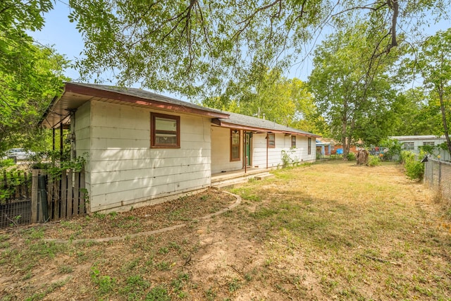 rear view of house with a yard