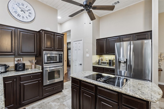 kitchen with dark brown cabinets and appliances with stainless steel finishes