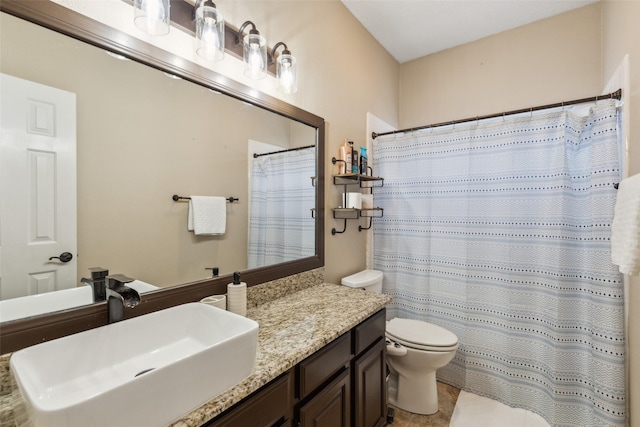 bathroom with vanity, walk in shower, and toilet