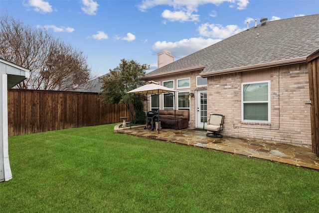 back of property featuring a patio and a yard