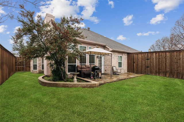 back of house featuring a gazebo, a lawn, and a patio area