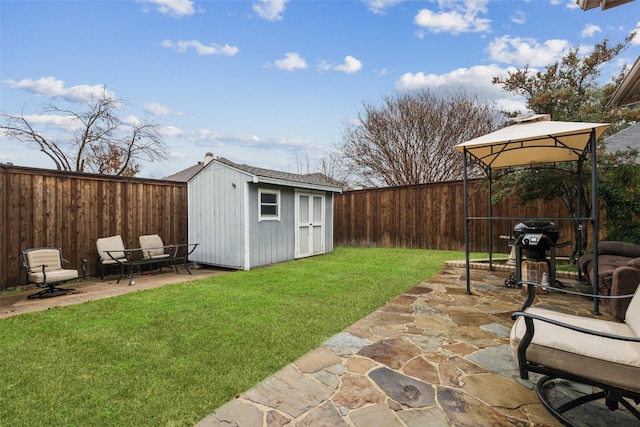 view of yard featuring a gazebo, a patio, and a storage unit