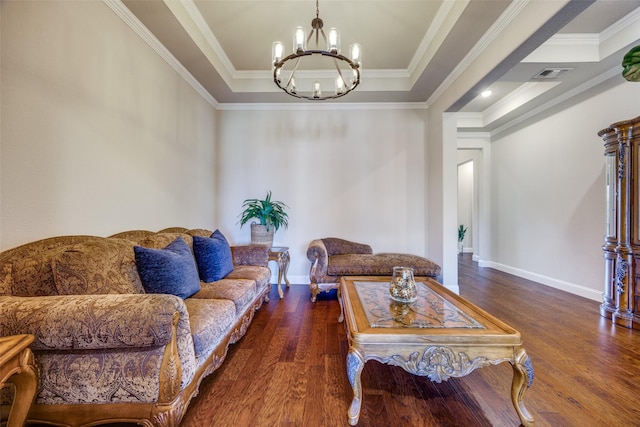 living room with a tray ceiling, a notable chandelier, crown molding, and dark hardwood / wood-style floors