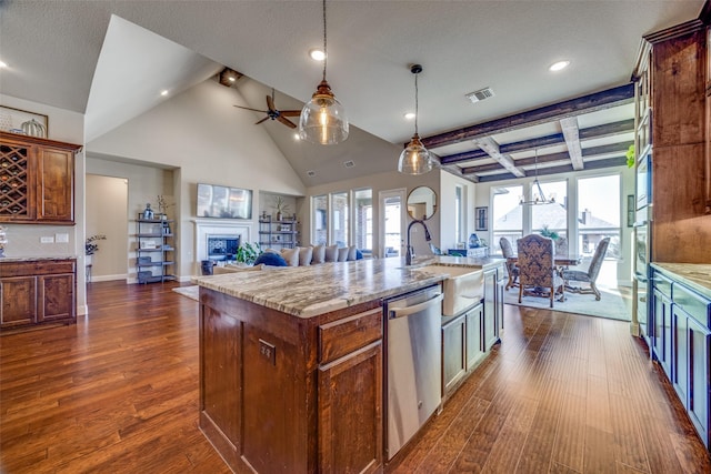 kitchen with sink, dark wood-type flooring, dishwasher, hanging light fixtures, and a center island with sink