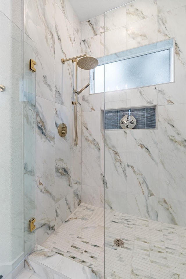 bathroom featuring an enclosed shower and plenty of natural light