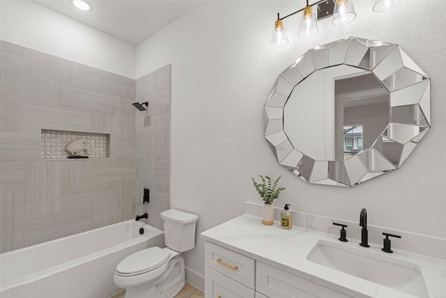 full bathroom with vanity, tiled shower / bath combo, and toilet