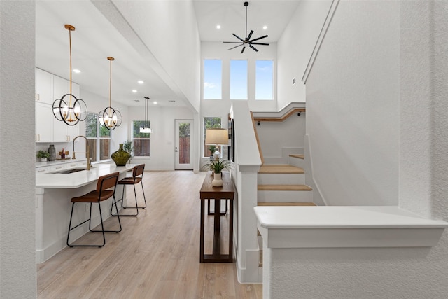 interior space with a high ceiling, sink, and hardwood / wood-style floors