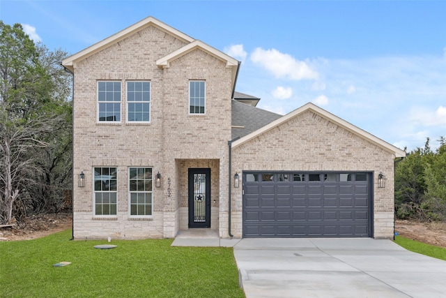 view of front of property with a garage and a front yard