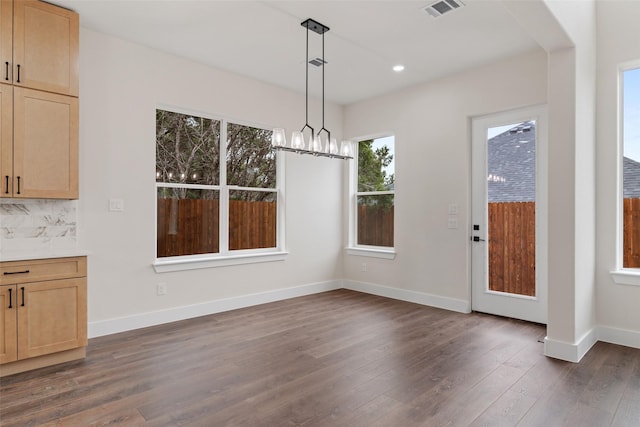 unfurnished dining area with dark hardwood / wood-style flooring