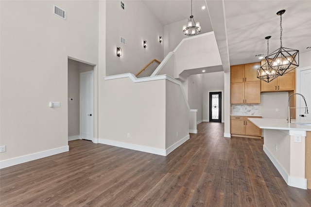 kitchen with dark hardwood / wood-style floors, decorative light fixtures, sink, and light brown cabinets