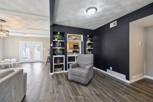 sitting room featuring wood-type flooring and french doors