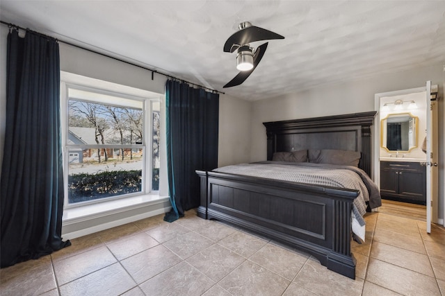 bedroom featuring light tile patterned flooring, ceiling fan, and ensuite bathroom