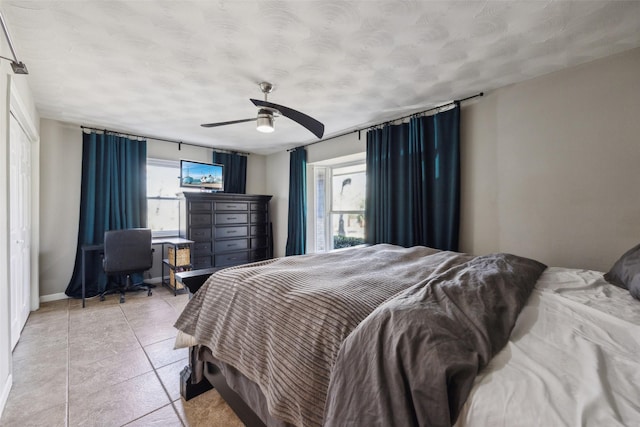 tiled bedroom with ceiling fan